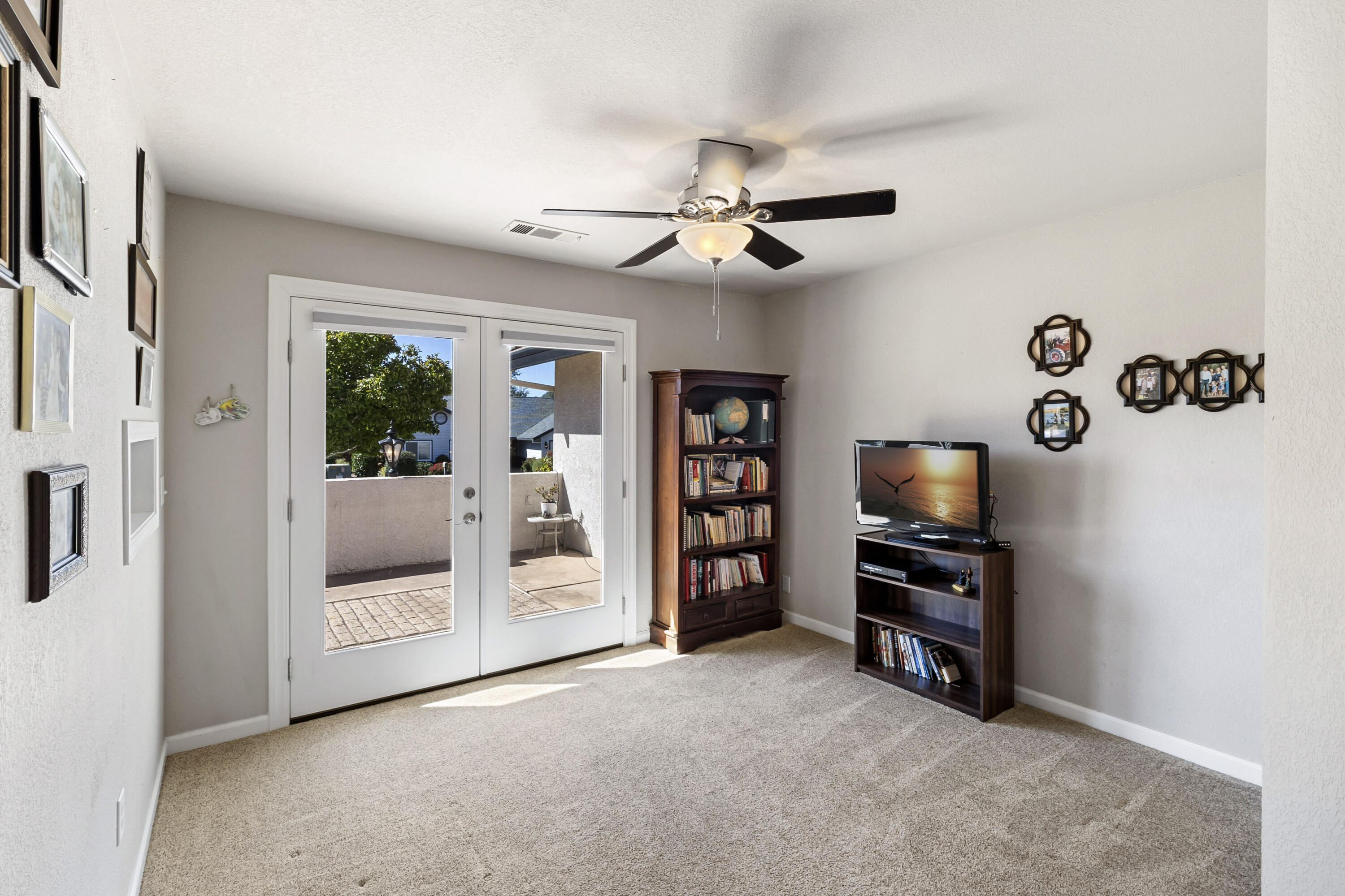 3884 Andes Drive Redding, CA 96001 - Photo 17 of 56 a view of a livingroom with a flat screen tv wooden floor and a ceiling fan