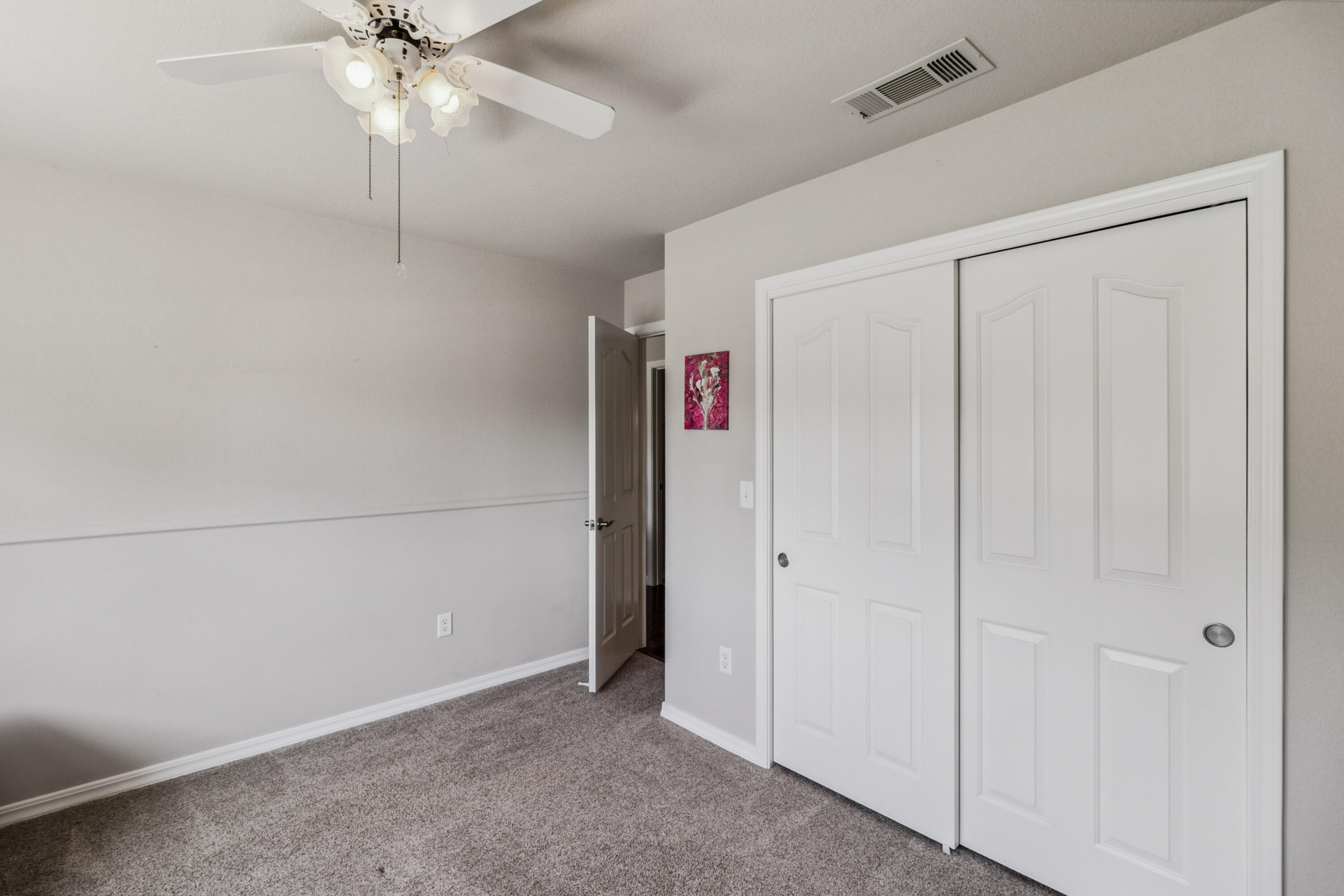 3884 Andes Drive Redding, CA 96001 - Photo 28 of 56 an empty room with a chandelier fan and closet