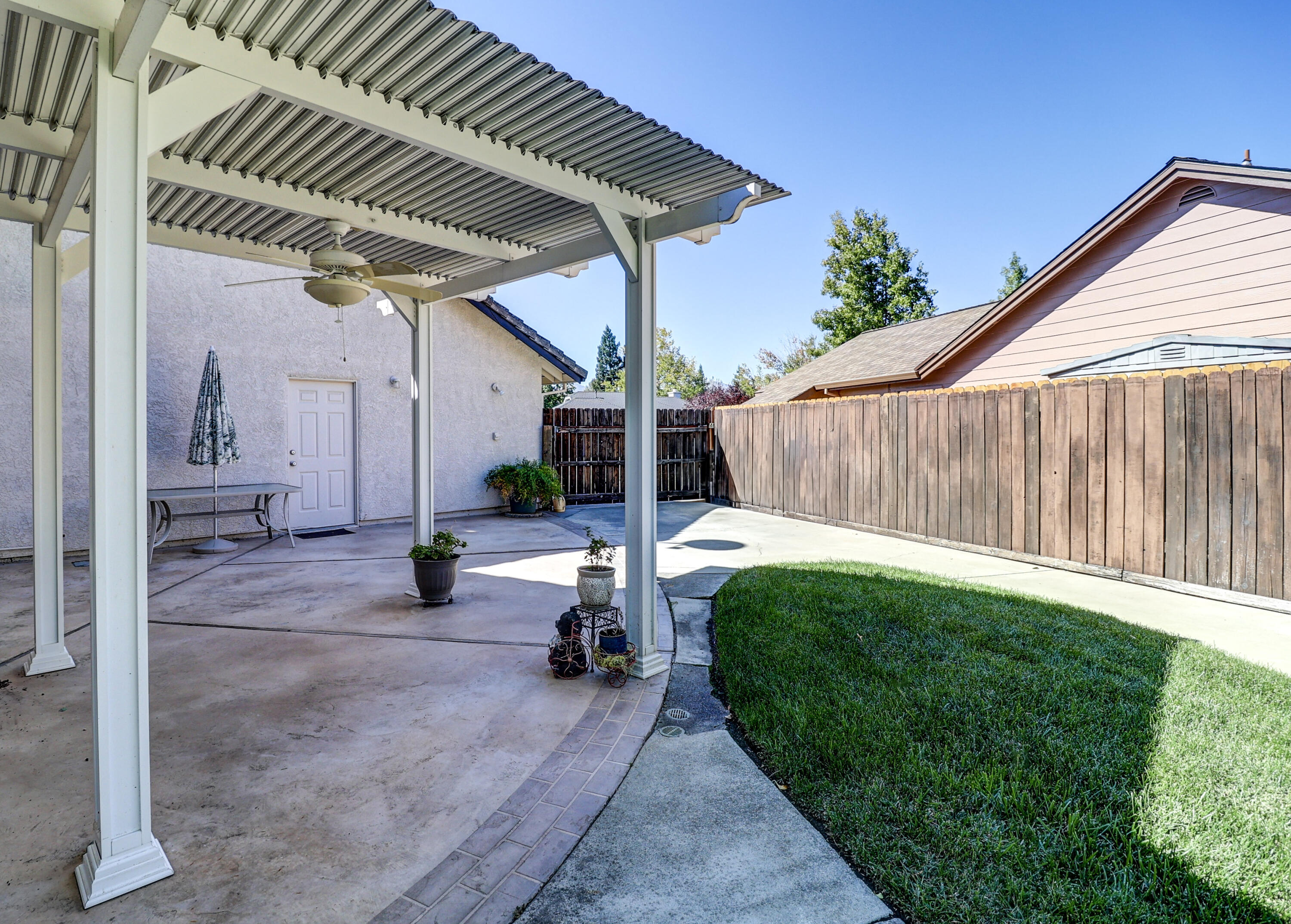 3884 Andes Drive Redding, CA 96001 - Photo 38 of 56 a view of a backyard with table and chairs potted plants