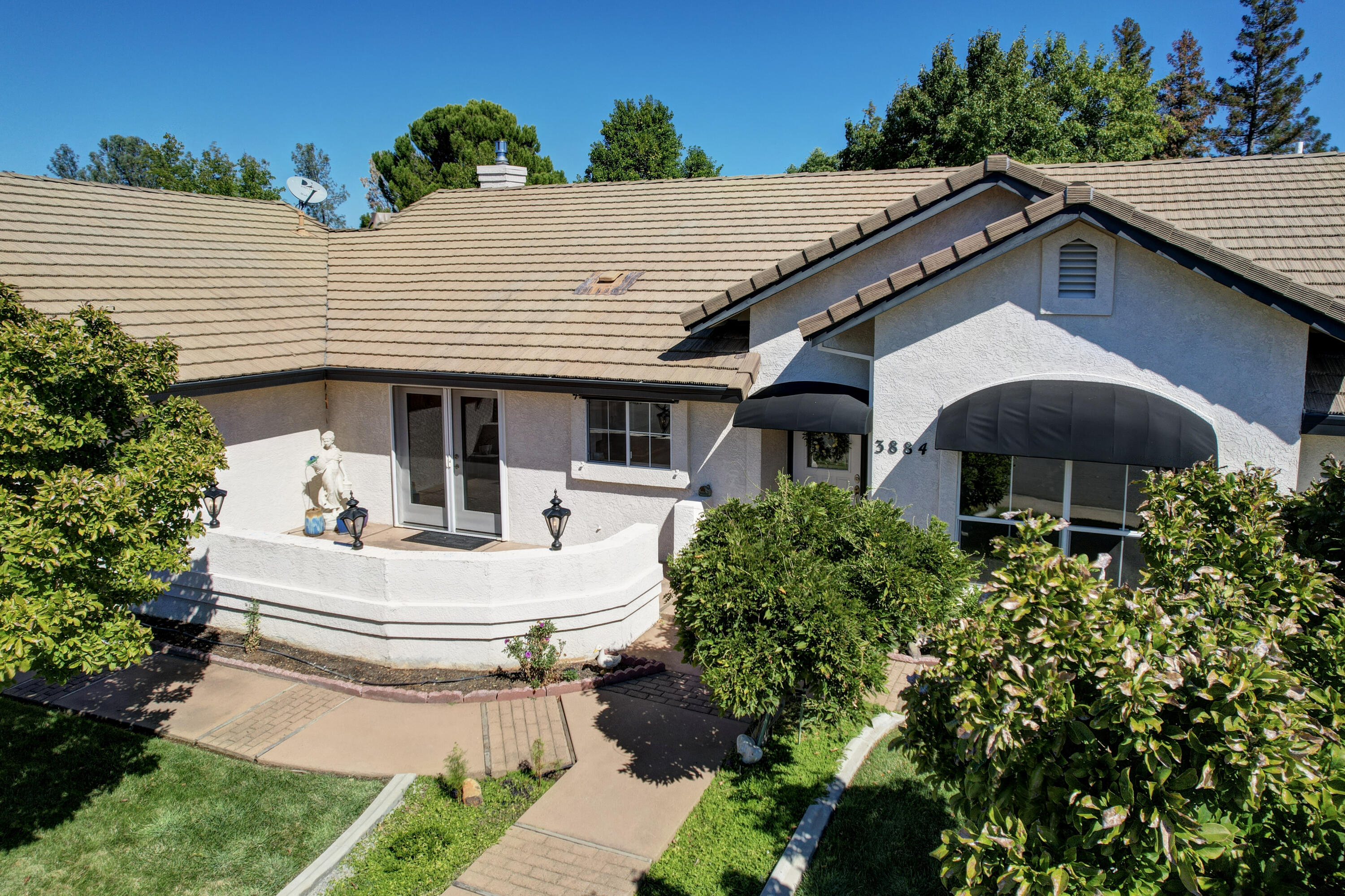3884 Andes Drive Redding, CA 96001 - Photo 53 of 56 a front view of a house with yard and outdoor seating