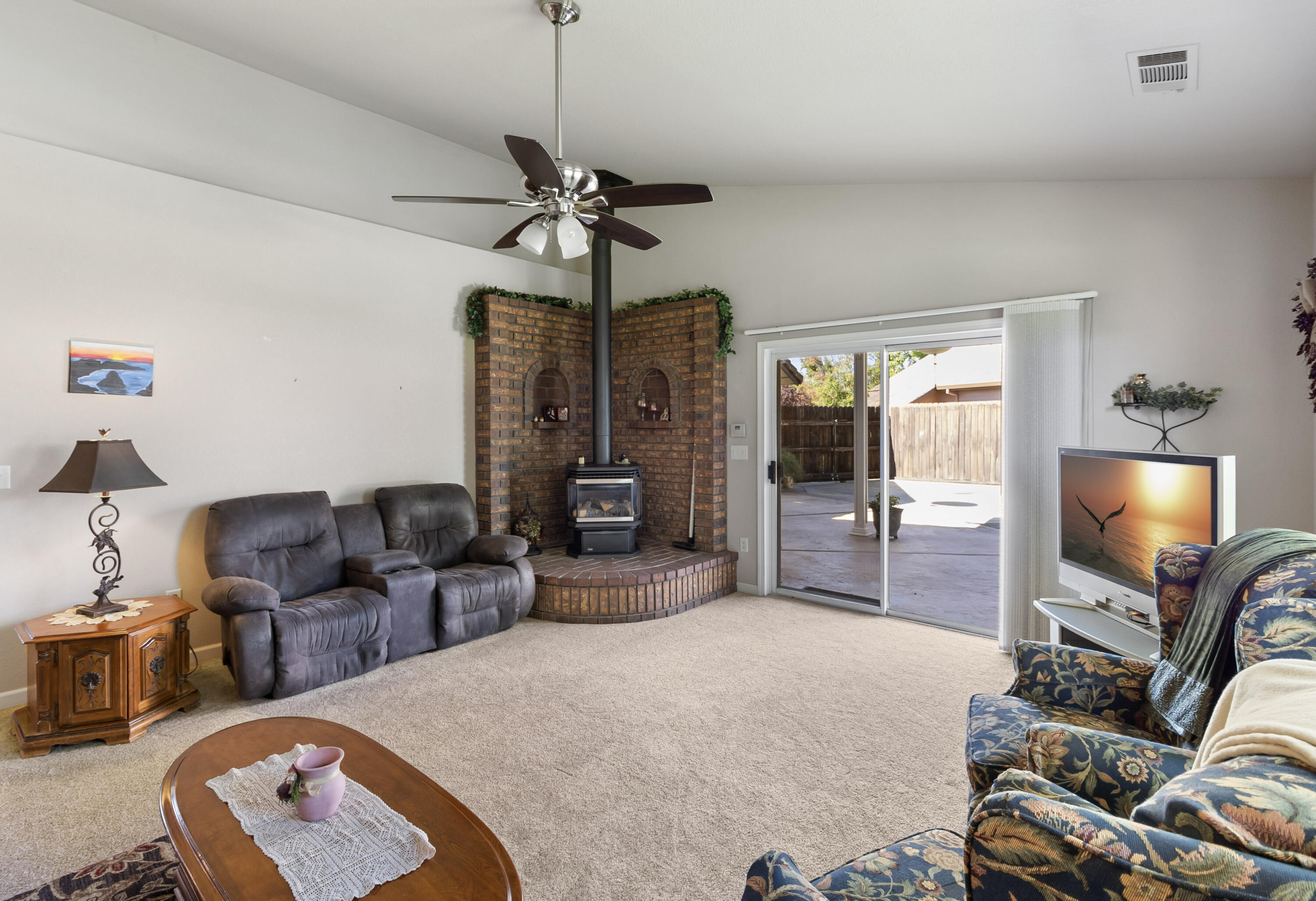 3884 Andes Drive Redding, CA 96001 - Photo 10 of 56 a living room with furniture a chandelier and a flat screen tv