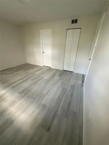 an empty room with wooden floor