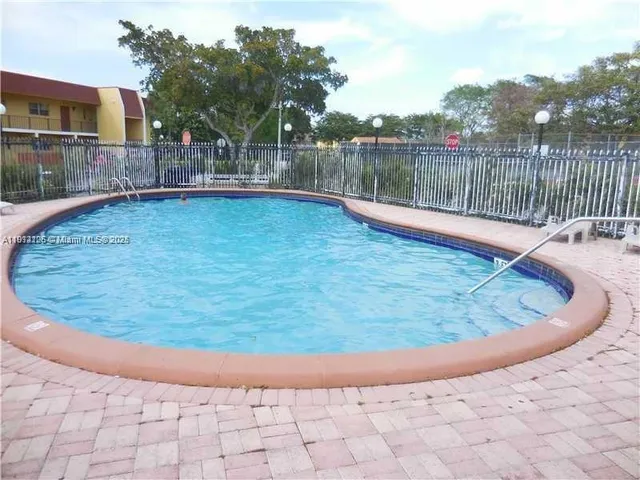 a view of a swimming pool with a yard