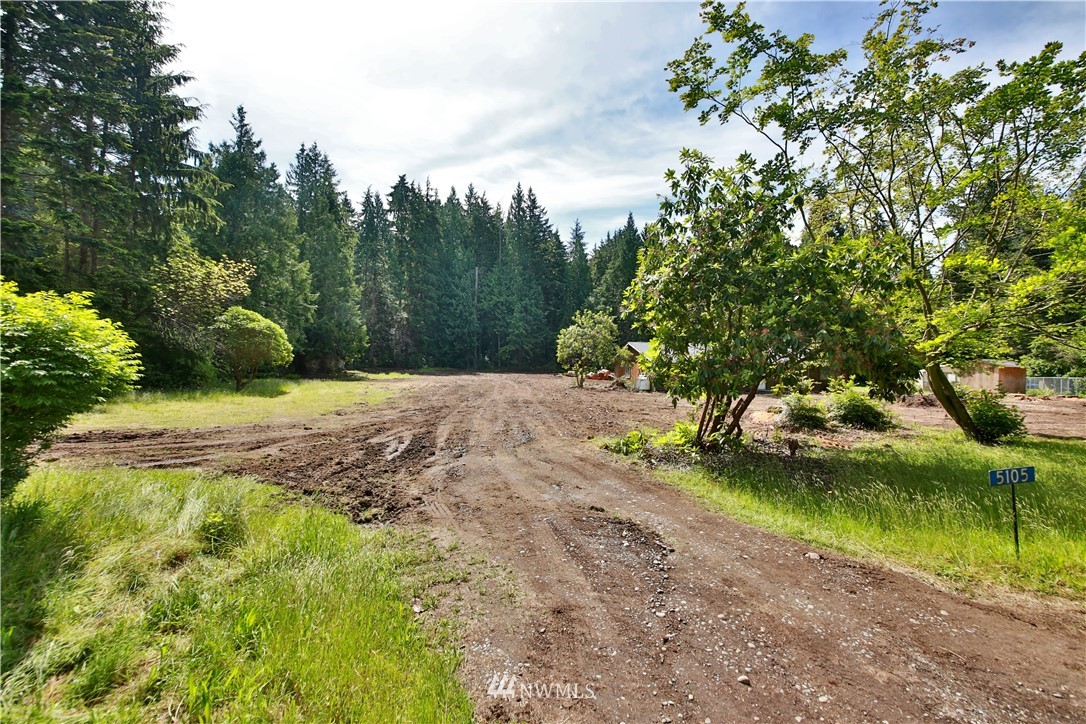 5105 East Harbor Road Freeland, WA 98249 - Photo 1 of 30 a view of a yard with plants and trees