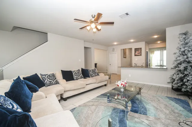 a living room with furniture and a chandelier