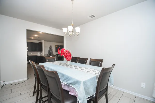 a view of a dining room with furniture and chandelier
