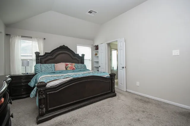 a bedroom with a bed and window