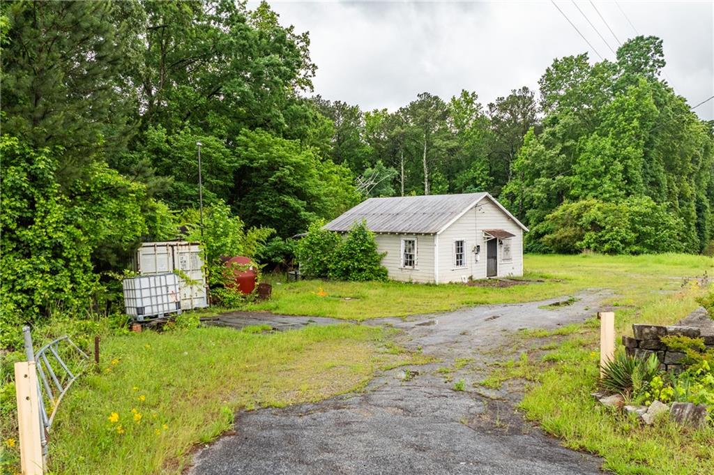 4410 Stacks Road Atlanta, GA 30349 - Photo 1 of 10 a view of a big house with a big yard plants and large trees