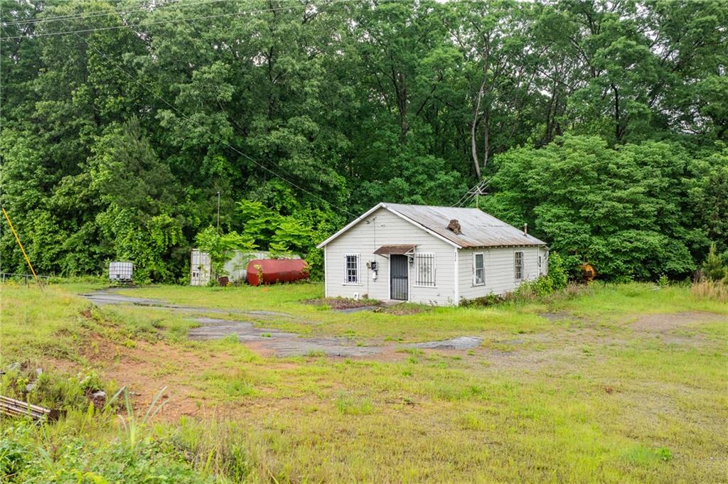 4410 Stacks Road Atlanta, GA 30349 - Photo 2 of 10 a view of a big house with a big yard and large trees