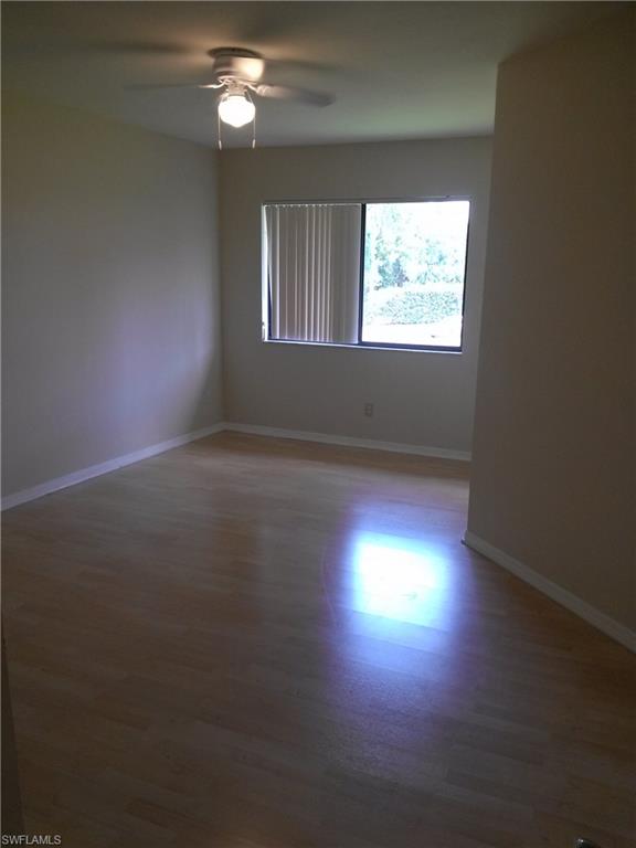 110 Bennington Drive, Unit 8 Naples, FL 34104 - Photo 12 of 18 a view of room with hardwood floor and window