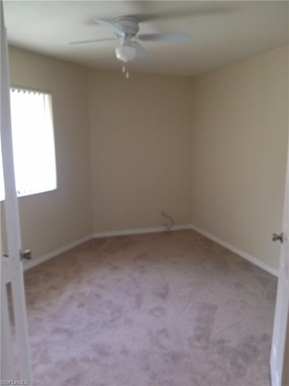 110 Bennington Drive, Unit 8 Naples, FL 34104 - Photo 13 of 18 an empty room with a window