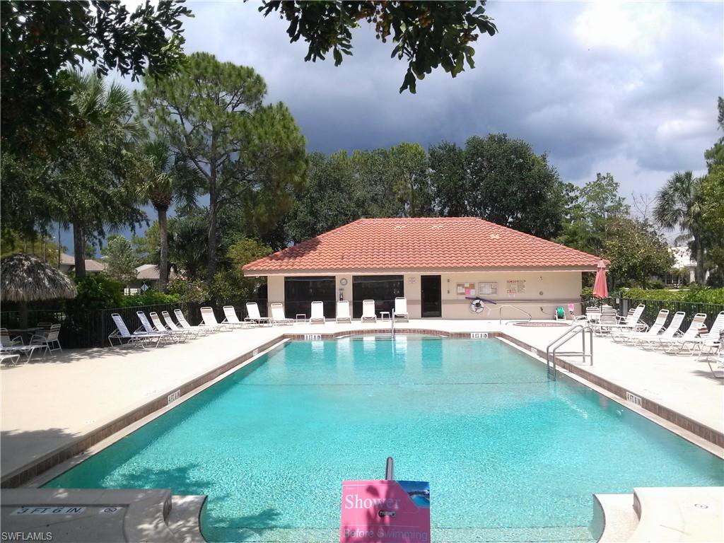 110 Bennington Drive, Unit 8 Naples, FL 34104 - Photo 17 of 18 a view of a house with pool and chairs