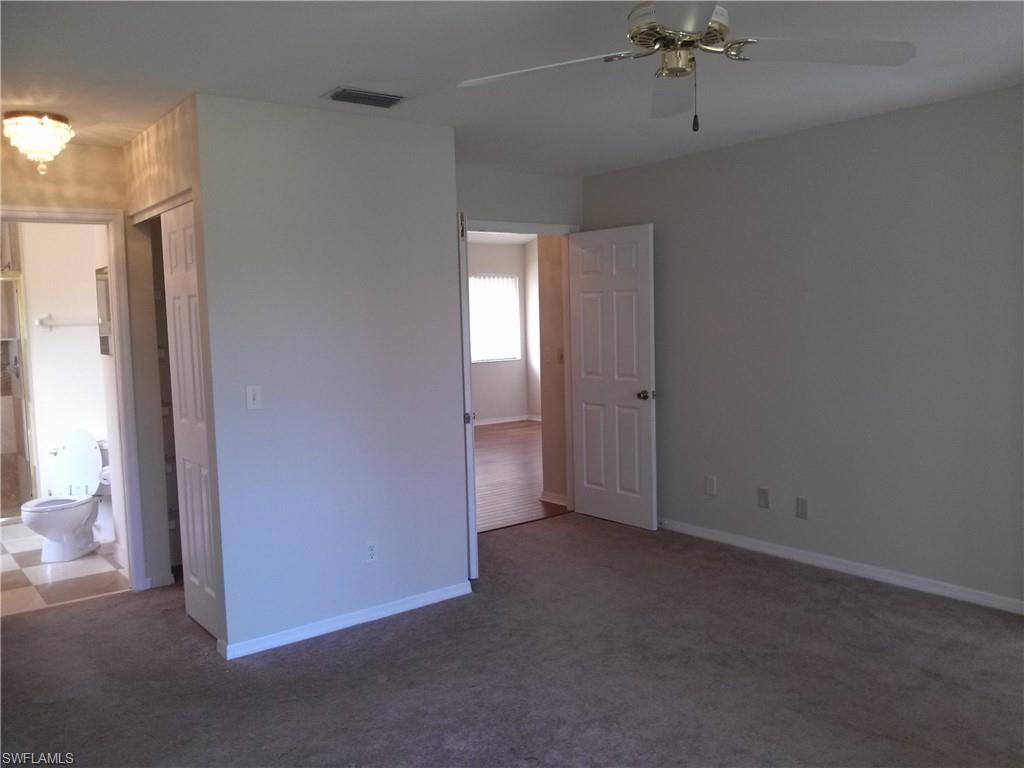 110 Bennington Drive, Unit 8 Naples, FL 34104 - Photo 6 of 18 a view of an empty room with a window