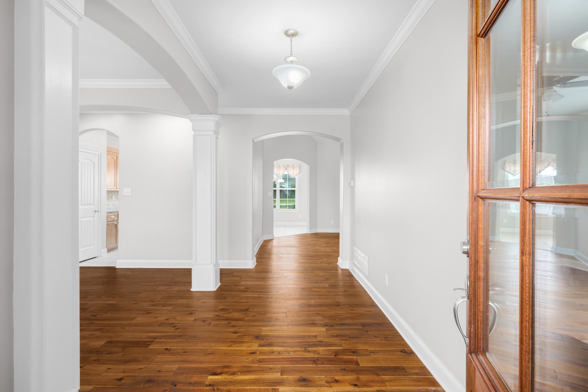 33 Ward Lane Atoka, TN 38004 - Photo 28 of 29 a view of a hallway with wooden floor and a chandelier