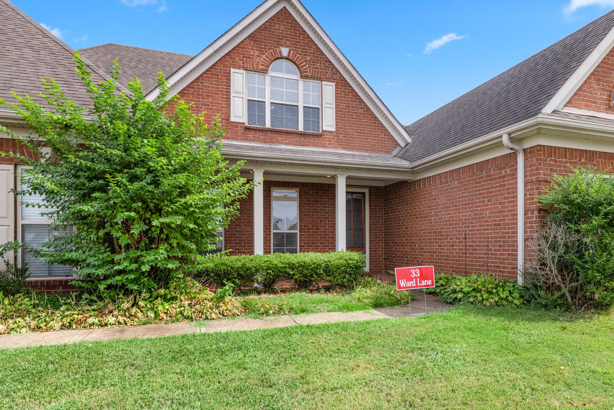 33 Ward Lane Atoka, TN 38004 - Photo 3 of 29 a front view of a house with a yard and garage