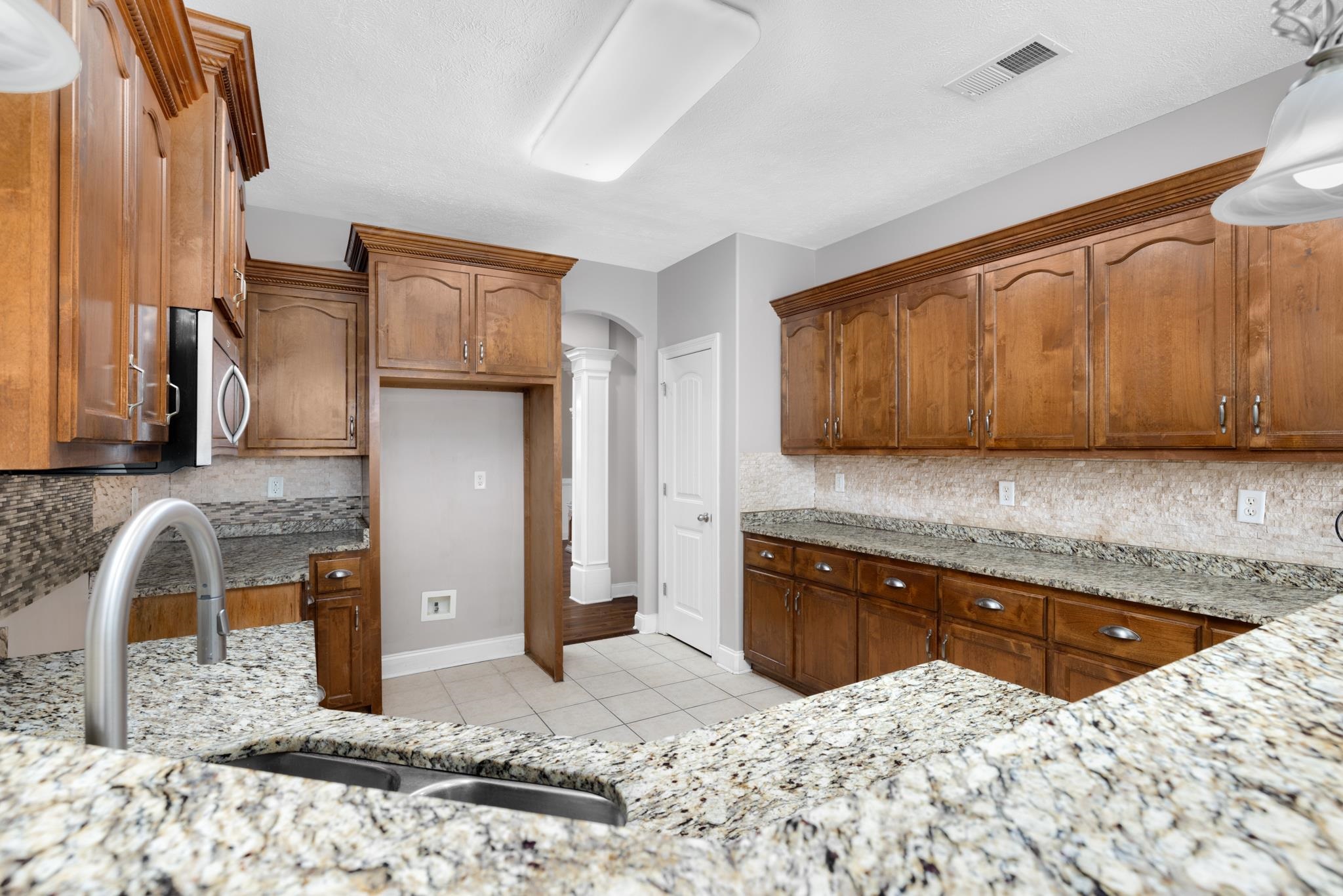 33 Ward Lane Atoka, TN 38004 - Photo 7 of 29 a kitchen with stainless steel appliances kitchen island granite countertop a sink and cabinets