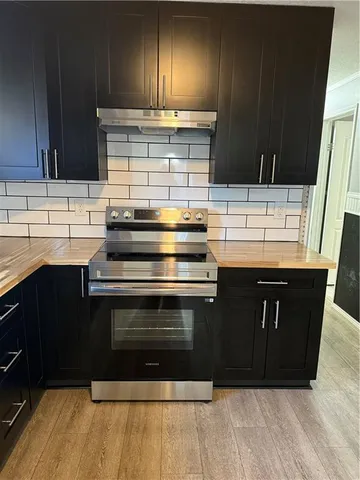 a kitchen with stainless steel appliances wooden cabinets and a sink