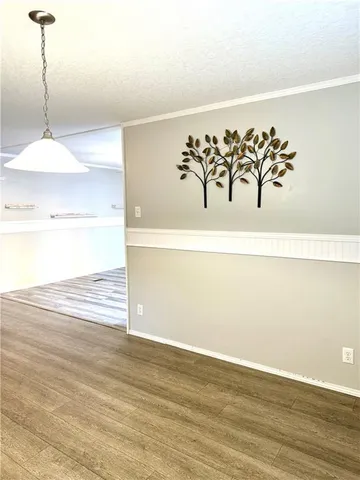a view of a room with wooden floor and window