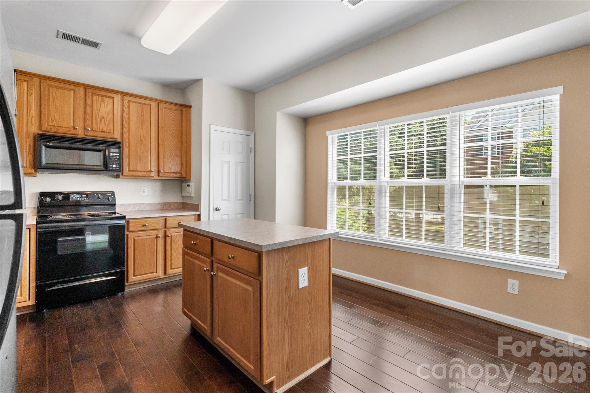 104 Rock Ridge Lane Mount Holly, NC 28120 - Photo 18 of 48 a kitchen with stainless steel appliances a stove sink and microwave