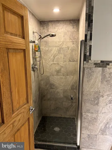 a bathroom with a glass door shower