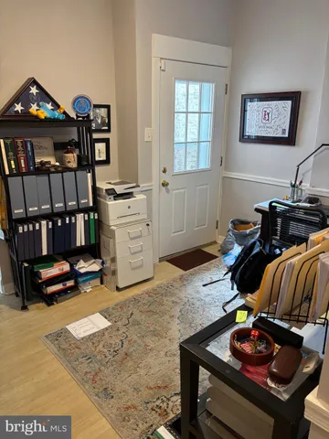 a living room with furniture gym equipment and a window