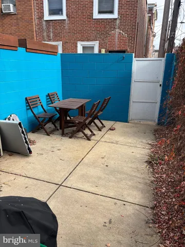 a backyard of a house with table and chairs