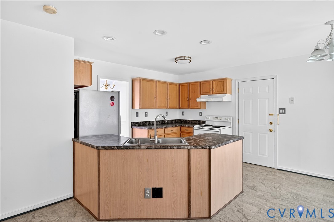 6125 Waterman Place Chesterfield, VA 23832 - Photo 11 of 45 a kitchen with stainless steel appliances granite countertop a sink and a refrigerator
