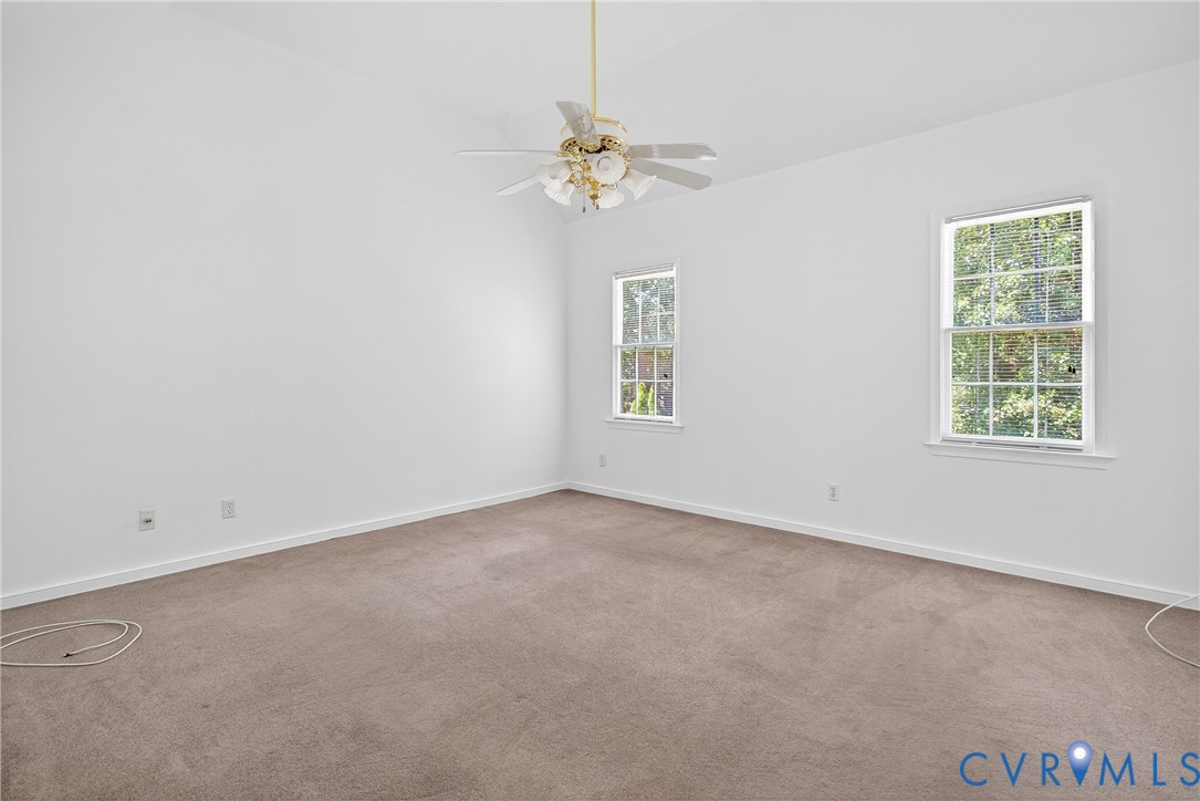 6125 Waterman Place Chesterfield, VA 23832 - Photo 22 of 45 an empty room with a chandelier fan and windows