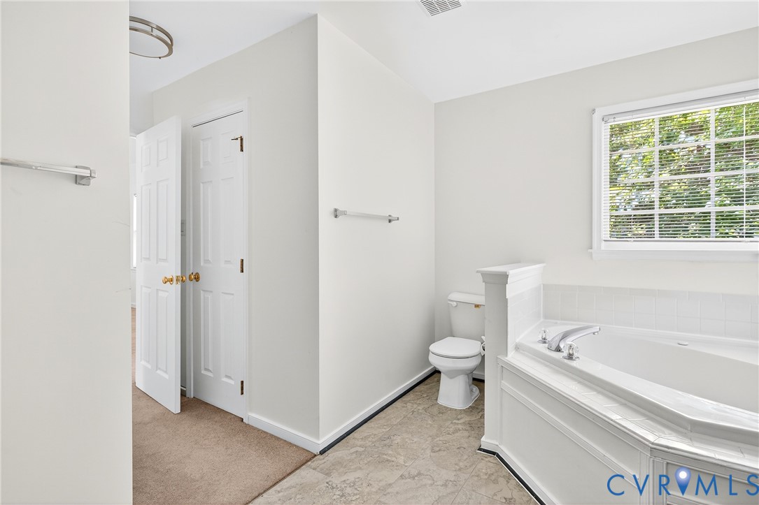 6125 Waterman Place Chesterfield, VA 23832 - Photo 26 of 45 a bathroom with a bathtub toilet and window
