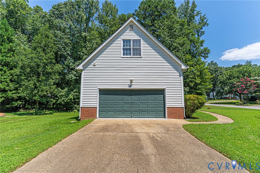 6125 Waterman Place Chesterfield, VA 23832 - Photo 35 of 45 Garage featuring concrete driveway and view of sca