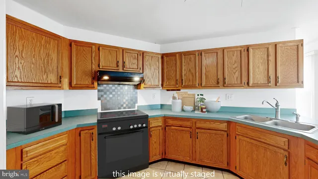 a kitchen with granite countertop cabinets stainless steel appliances a sink and wooden floor