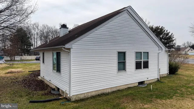 a bird view of house next to a building