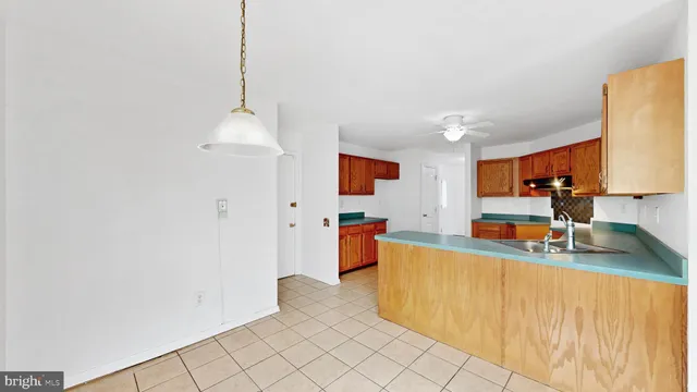 a kitchen with stainless steel appliances granite countertop a sink refrigerator and cabinets