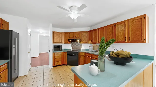 a kitchen with stainless steel appliances granite countertop a sink a stove and a refrigerator