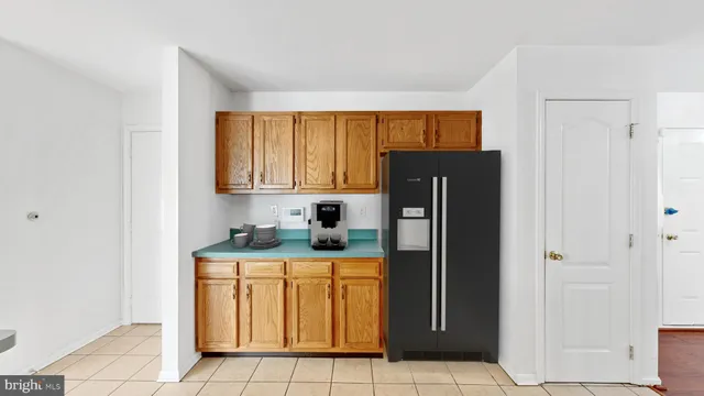 a kitchen with a refrigerator sink and cabinets
