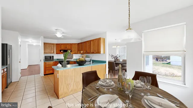 a living room with furniture kitchen view and a chandelier