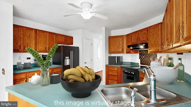 a room with furniture cabinetry a potted plant and a window