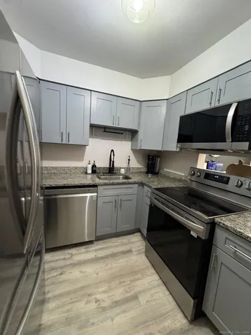 a kitchen with a sink stove and microwave