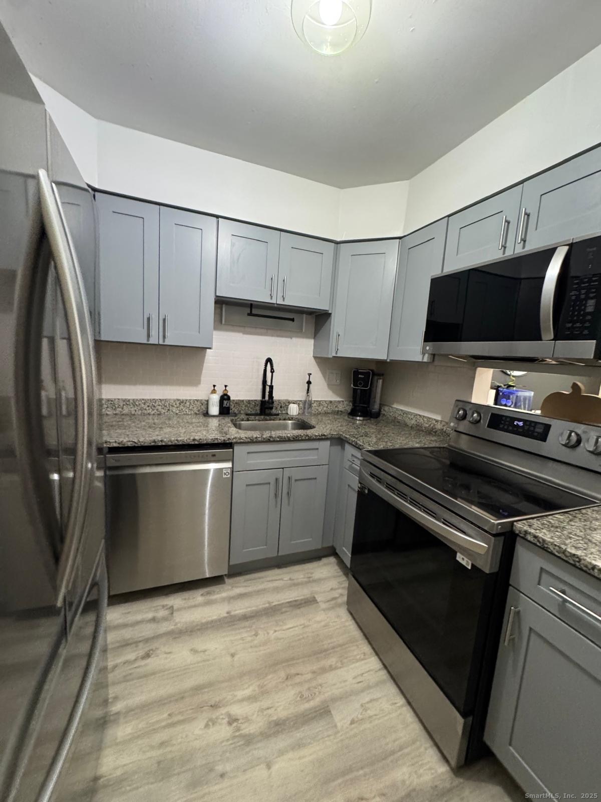 a kitchen with a sink stove and microwave