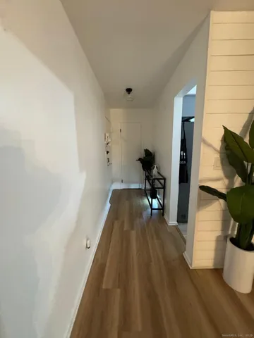 a view of utility room and wooden floor