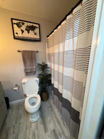 a white toilet sitting next to a bathroom sink
