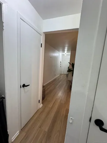 a view of hallway with wooden floor