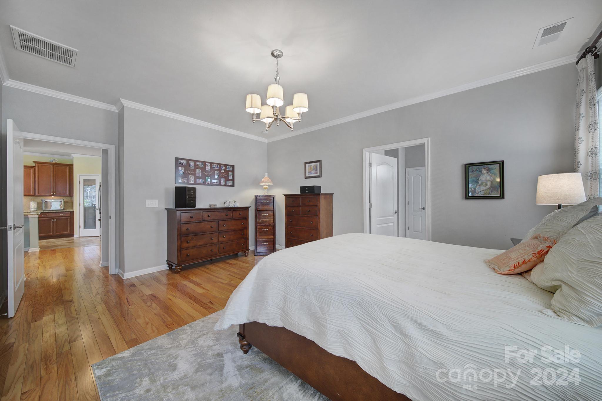 4362 Perth Road Fort Mill, SC 29707 - Photo 13 of 34 a spacious bedroom with a bed and wooden floor