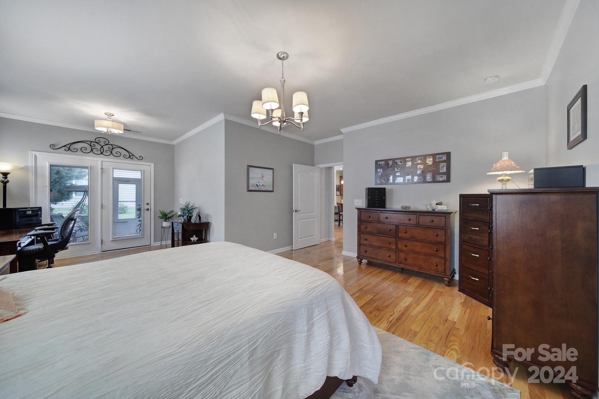 4362 Perth Road Fort Mill, SC 29707 - Photo 14 of 34 a spacious bedroom with a bed and wooden floor