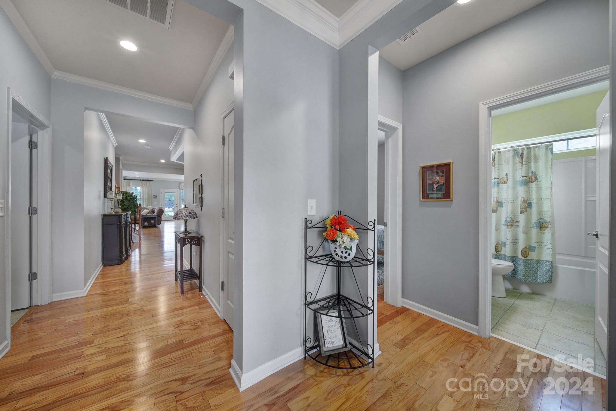 4362 Perth Road Fort Mill, SC 29707 - Photo 2 of 34 a view of a hallway with wooden floor and a living room