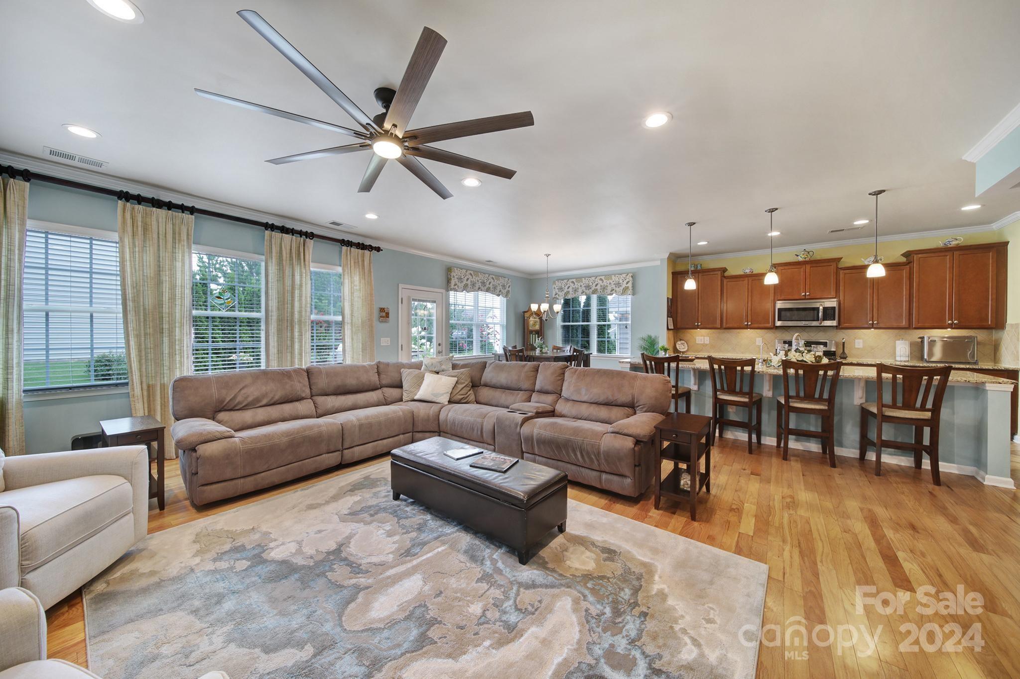 4362 Perth Road Fort Mill, SC 29707 - Photo 10 of 34 a living room with furniture kitchen area and a ceiling fan