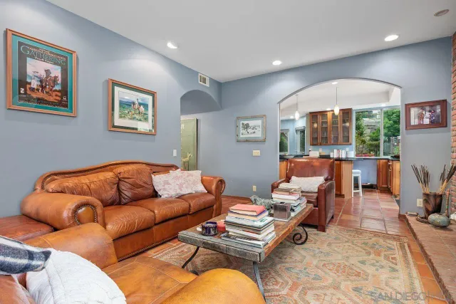a living room with furniture fireplace and a large mirror