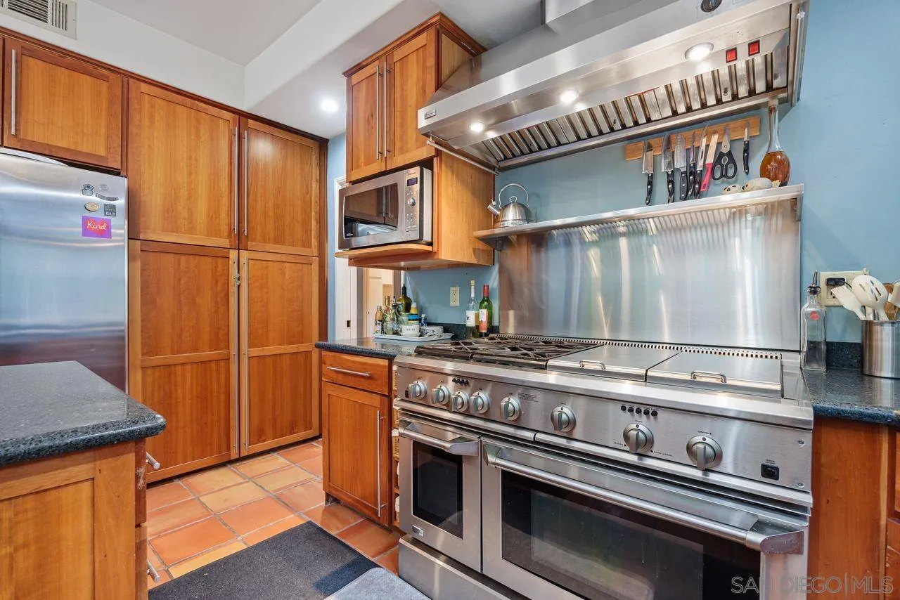 2238 Oceanview Road Oceanside, CA 92056 - Photo 15 of 50 a kitchen with stainless steel appliances granite countertop a stove and a refrigerator