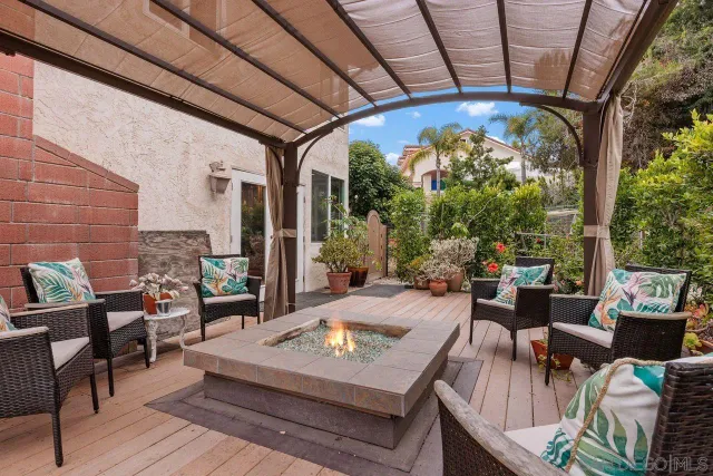 a living room with patio furniture and a floor to ceiling window
