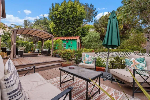 a view of a patio with table and chairs and potted plants